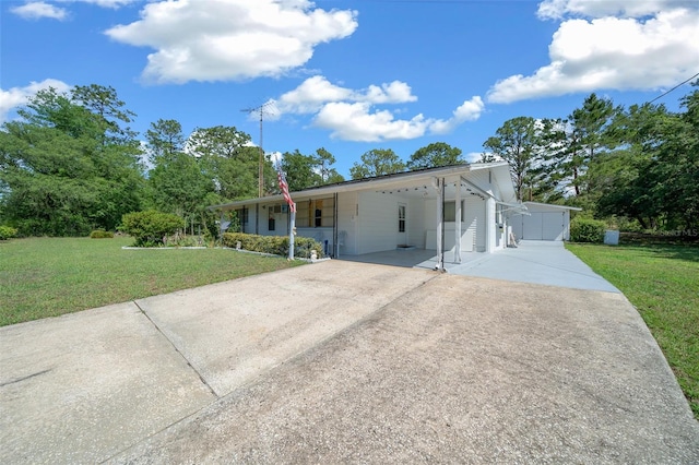 23737 NW Mallard Ave, Dunnellon, FL 34431 - view of front of property with concrete driveway, an attached carport, and a front yard