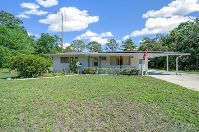 23737 NW Mallard Ave, Dunnellon, FL 34431 - view of front of property featuring a porch, driveway, a front yard, and an attached carport