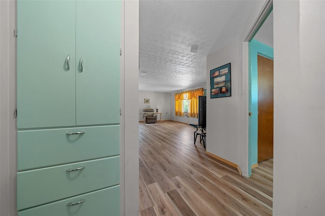 23737 NW Mallard Ave, Dunnellon, FL 34431 - hall with a textured ceiling, light wood-style flooring, and baseboards