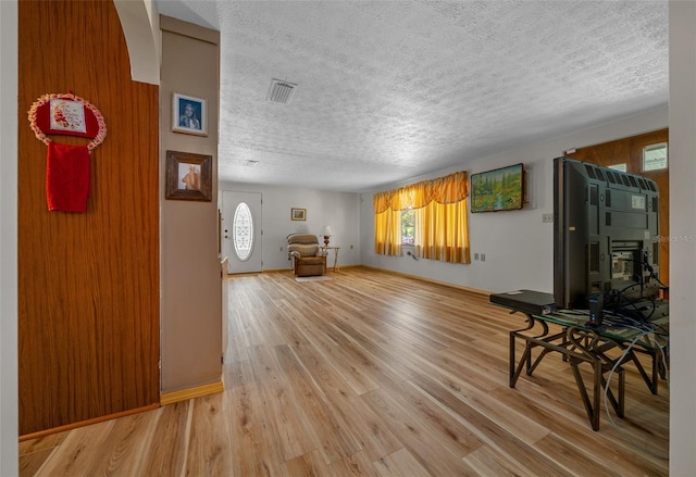 23737 NW Mallard Ave, Dunnellon, FL 34431 - living room with a textured ceiling, visible vents, and light wood-type flooring
