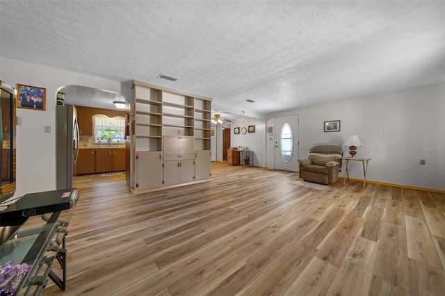 23737 NW Mallard Ave, Dunnellon, FL 34431 - living area featuring arched walkways, plenty of natural light, and a textured ceiling