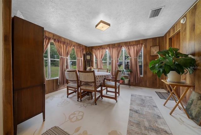 23737 NW Mallard Ave, Dunnellon, FL 34431 - dining area featuring a textured ceiling, visible vents, and wooden walls