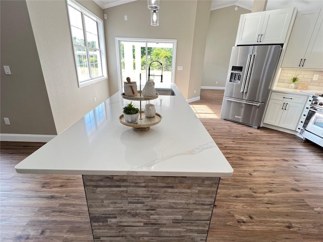 13430 NE 30th Ct, Anthony, FL 32617 - kitchen featuring high quality fridge, a sink, dark wood finished floors, crown molding, and white cabinets
