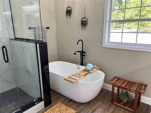 13430 NE 30th Ct, Anthony, FL 32617 - bathroom featuring wood finished floors, baseboards, a shower stall, and a textured wall