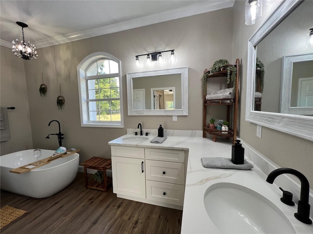 13430 NE 30th Ct, Anthony, FL 32617 - bathroom featuring crown molding, wood finished floors, a freestanding bath, and vanity