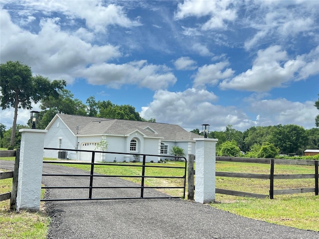 13430 NE 30th Ct, Anthony, FL 32617 - single story home with central AC unit, stucco siding, a gate, and driveway