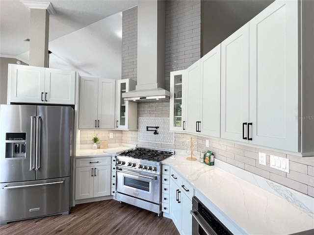 13430 NE 30th Ct, Anthony, FL 32617 - kitchen featuring high quality appliances, wall chimney exhaust hood, dark wood-style floors, glass insert cabinets, and tasteful backsplash