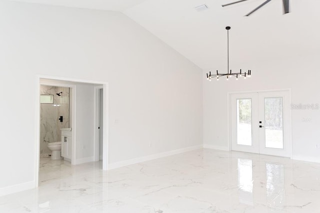 interior space with french doors, marble finish floor, baseboards, and high vaulted ceiling