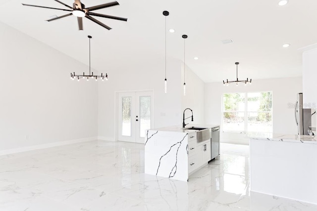 kitchen featuring french doors, a sink, stainless steel appliances, white cabinets, and marble finish floor