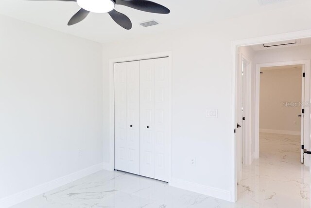 unfurnished bedroom featuring baseboards, marble finish floor, and visible vents