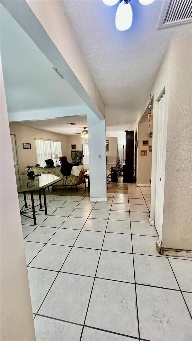 16850 SE 19th Ct, Summerfield, FL 34491 - hallway with light tile patterned floors and a textured ceiling