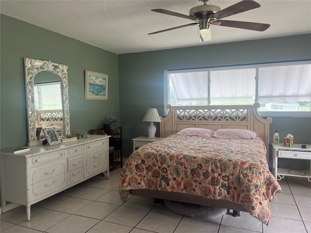 16850 SE 19th Ct, Summerfield, FL 34491 - bedroom with light tile patterned floors, multiple windows, ceiling fan, and a textured ceiling