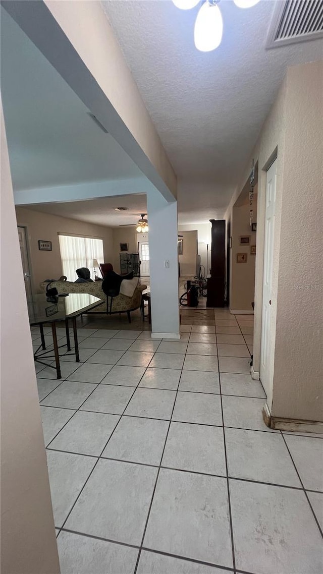 16850 SE 19th Ct, Summerfield, FL 34491 - hallway with light tile patterned floors and a textured ceiling