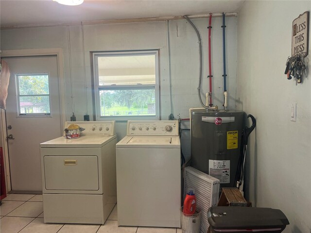 16850 SE 19th Ct, Summerfield, FL 34491 - washroom with water heater, separate washer and dryer, and light tile patterned floors