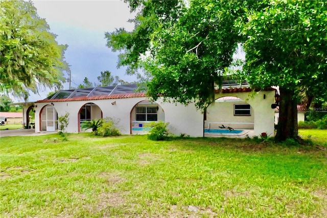 16850 SE 19th Ct, Summerfield, FL 34491 - back of house with a lawn and stucco siding