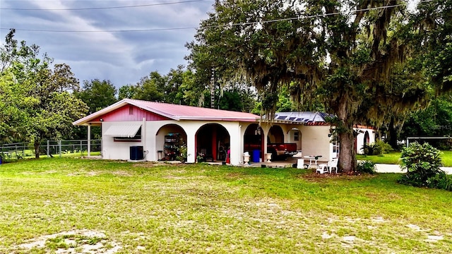 16850 SE 19th Ct, Summerfield, FL 34491 - view of front of property with metal roof, stucco siding, a patio, and view of wooded area