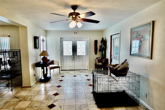 16850 SE 19th Ct, Summerfield, FL 34491 - entrance foyer featuring plenty of natural light, a ceiling fan, a textured ceiling, a textured wall, and light tile patterned floors