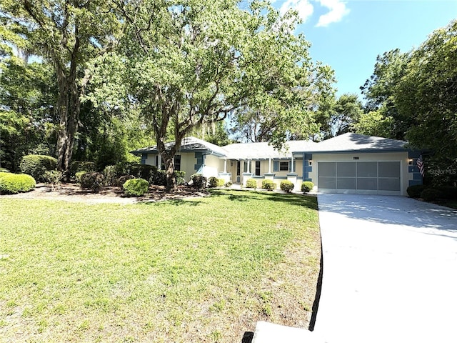 ranch-style house with an attached garage, a front lawn, stucco siding, and driveway