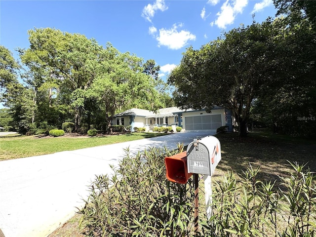 ranch-style house featuring an attached garage and driveway