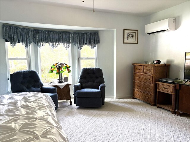 bedroom featuring a wall mounted AC and light carpet