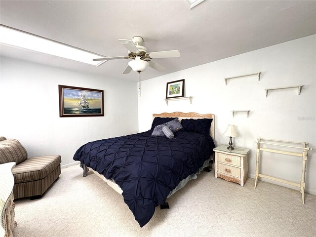 carpeted bedroom featuring baseboards and a ceiling fan