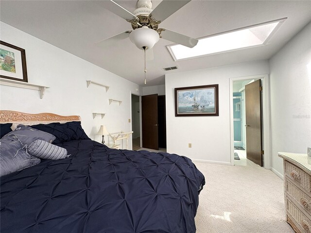 carpeted bedroom with visible vents, baseboards, ceiling fan, and a skylight