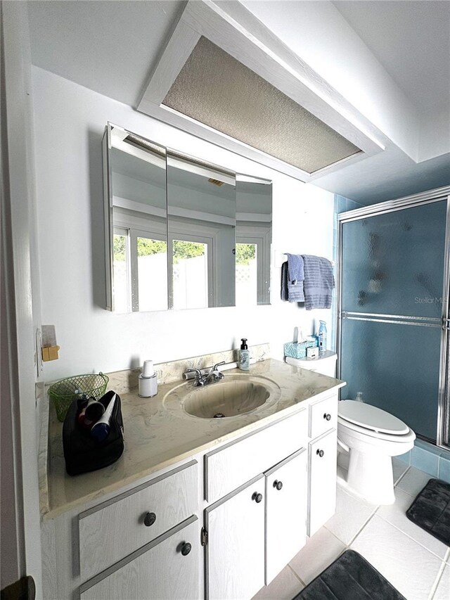 full bathroom with toilet, tile patterned floors, a shower stall, and vanity