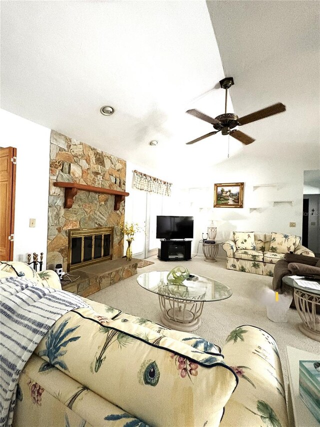 living room featuring a stone fireplace, carpet, ceiling fan, and lofted ceiling