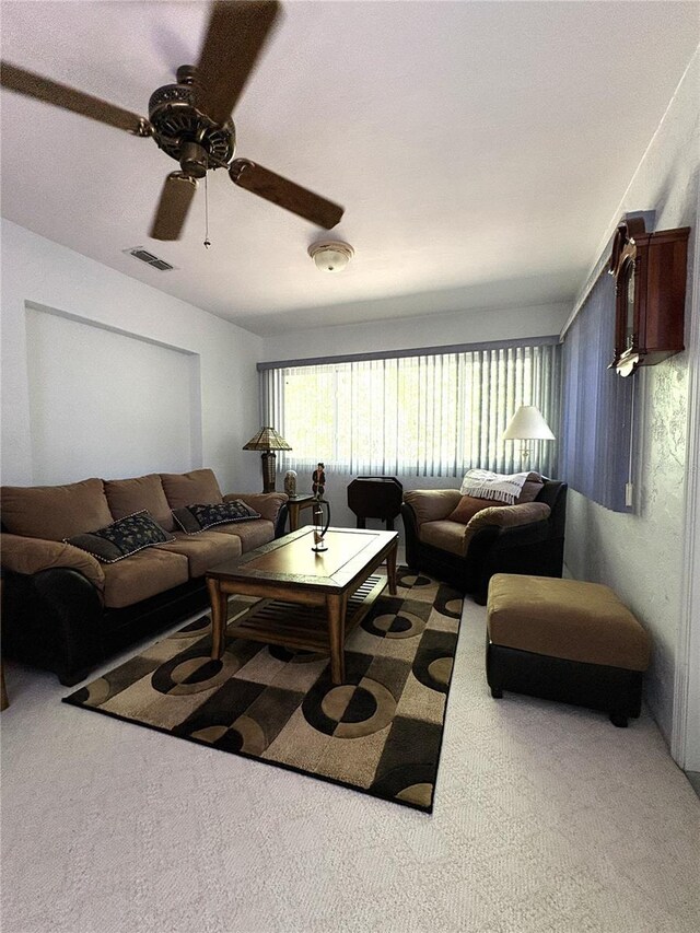carpeted living room featuring ceiling fan and visible vents