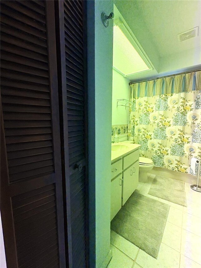 bathroom with vanity, tile patterned flooring, toilet, and visible vents