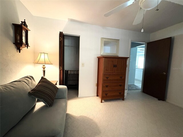 interior space featuring a closet, a ceiling fan, and light carpet