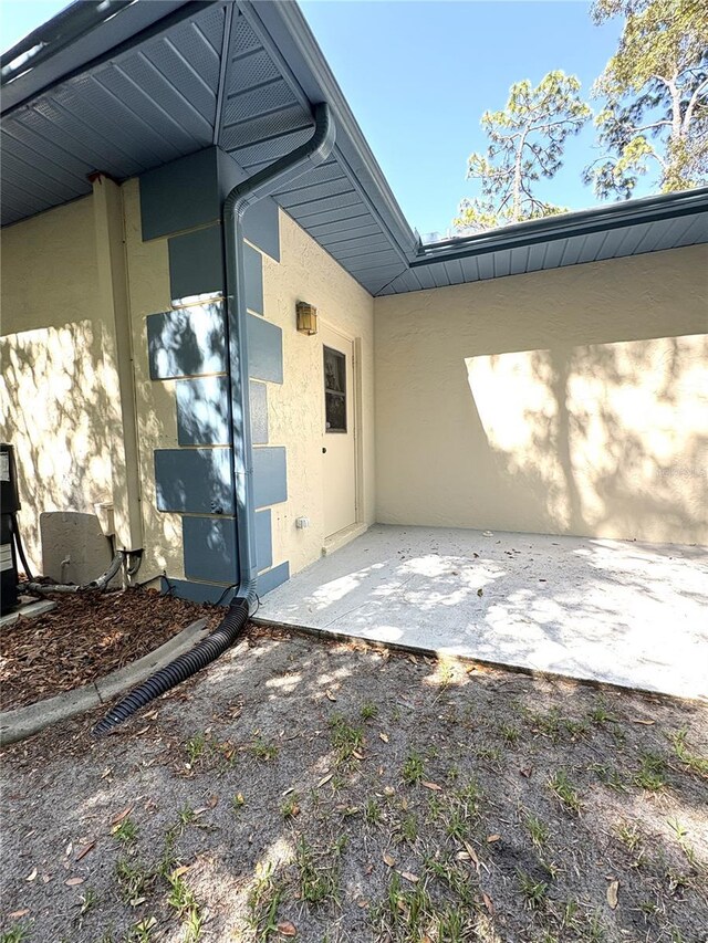 exterior space with a patio and stucco siding