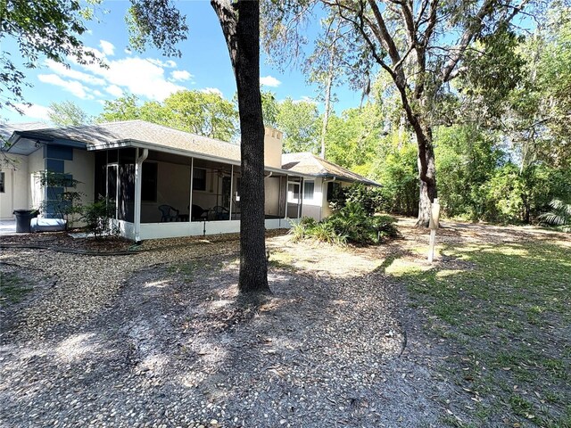 exterior space with a sunroom and stucco siding