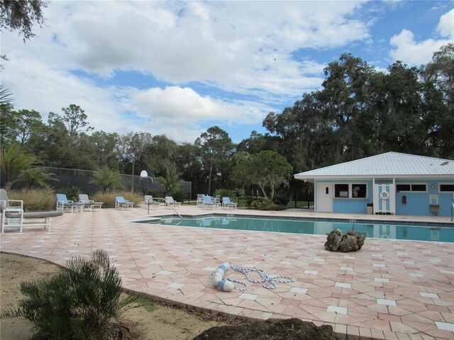 community pool featuring a patio and fence
