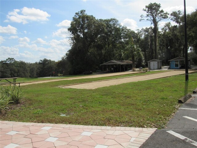 view of yard with a shed and an outbuilding
