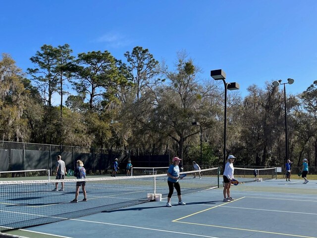 view of tennis court with fence