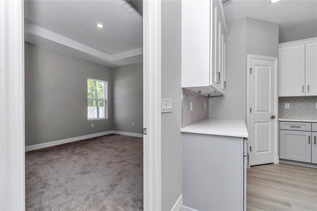 kitchen with light countertops, recessed lighting, baseboards, backsplash, and visible vents