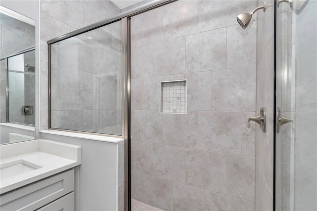 full bathroom featuring vanity and a shower stall