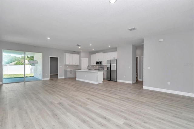 9405 SE 159th Ln, Summerfield, FL 34491 - unfurnished living room featuring baseboards, light wood finished floors, and recessed lighting