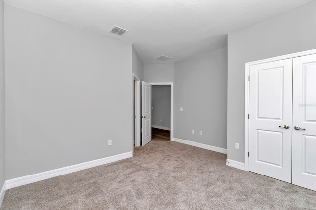 9405 SE 159th Ln, Summerfield, FL 34491 - unfurnished bedroom with carpet flooring, baseboards, and a closet