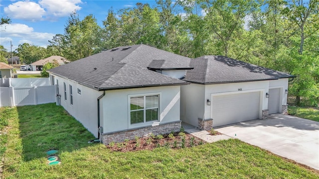 9405 SE 159th Ln, Summerfield, FL 34491 - view of front of home featuring a garage, stucco siding, concrete driveway, and roof with shingles