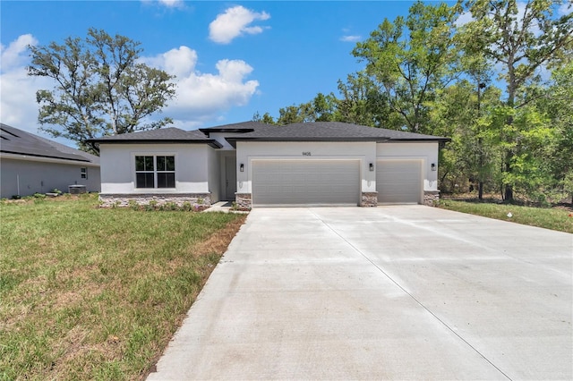 9405 SE 159th Ln, Summerfield, FL 34491 - prairie-style house with stone siding, a garage, driveway, and stucco siding
