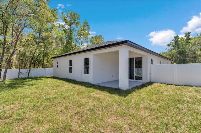 9405 SE 159th Ln, Summerfield, FL 34491 - back of property with stucco siding and a patio