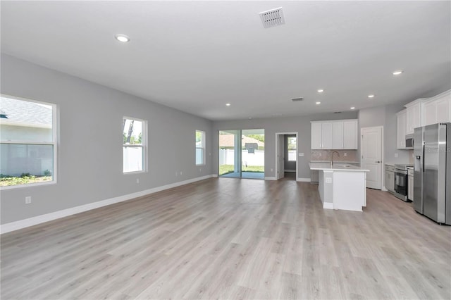 9405 SE 159th Ln, Summerfield, FL 34491 - kitchen featuring stainless steel appliances, open floor plan, light countertops, healthy amount of natural light, and recessed lighting