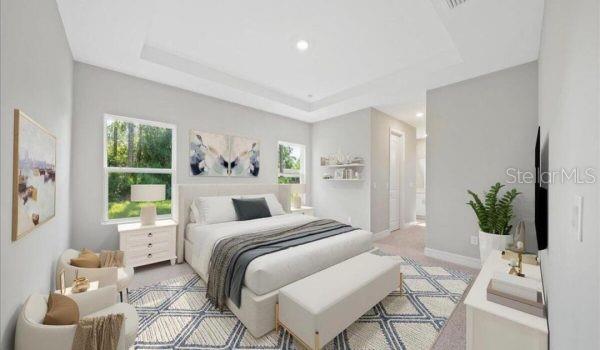 9405 SE 159th Ln, Summerfield, FL 34491 - bedroom featuring recessed lighting, a raised ceiling, and baseboards
