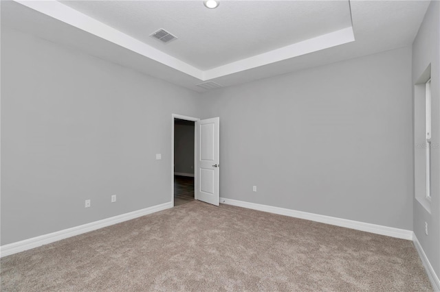 9405 SE 159th Ln, Summerfield, FL 34491 - carpeted empty room with a tray ceiling and baseboards