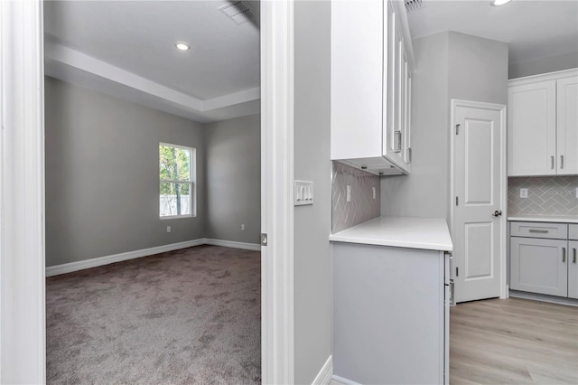 9405 SE 159th Ln, Summerfield, FL 34491 - kitchen with backsplash, baseboards, light countertops, recessed lighting, and white cabinets