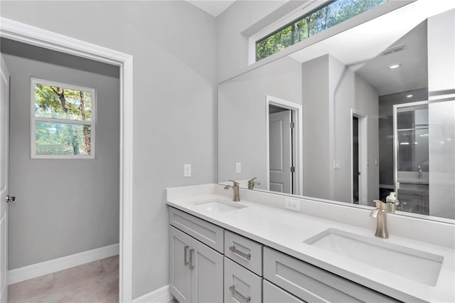 9405 SE 159th Ln, Summerfield, FL 34491 - bathroom with double vanity, plenty of natural light, and baseboards