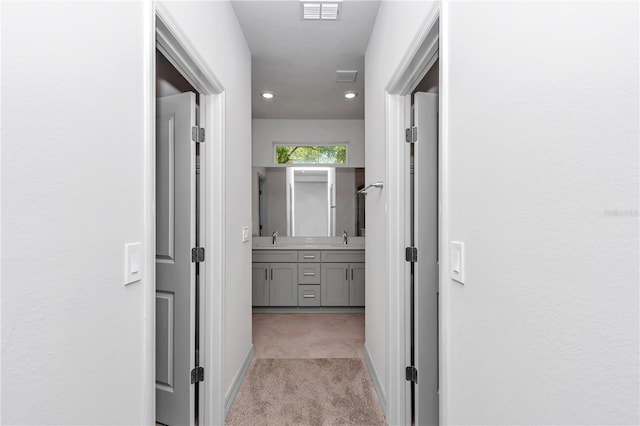 9405 SE 159th Ln, Summerfield, FL 34491 - hall with light colored carpet, a sink, baseboards, and recessed lighting
