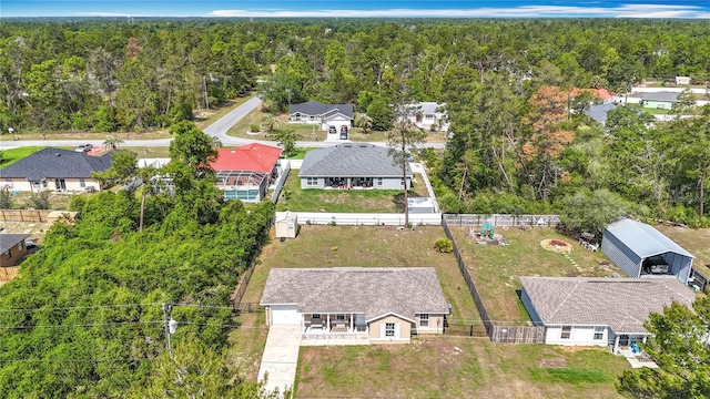 aerial perspective of suburban area featuring a heavily wooded area